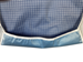 Close up of crumb catcher area of blue and white pattern adult bib