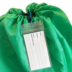 Clear vinyl sleeve attached to a laundry bag with a cable tie