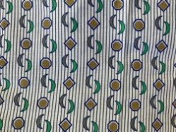 Closeup of Shoulder Snap Gown with Green and Brown Geometric Patterns