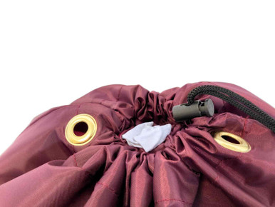 Closeup of toggle and drawstring on a burgundy small laundry bag
