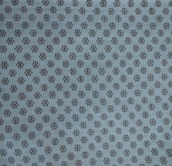 Closeup of the Economy Blue Patient Gown. Blue Background with Black Flower Pattern