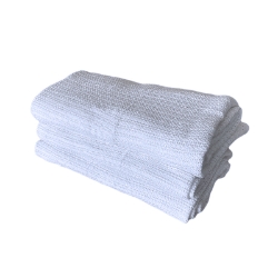 Stack of three open weave white blankets